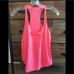 Bright coral pink racerback tank in size Small
